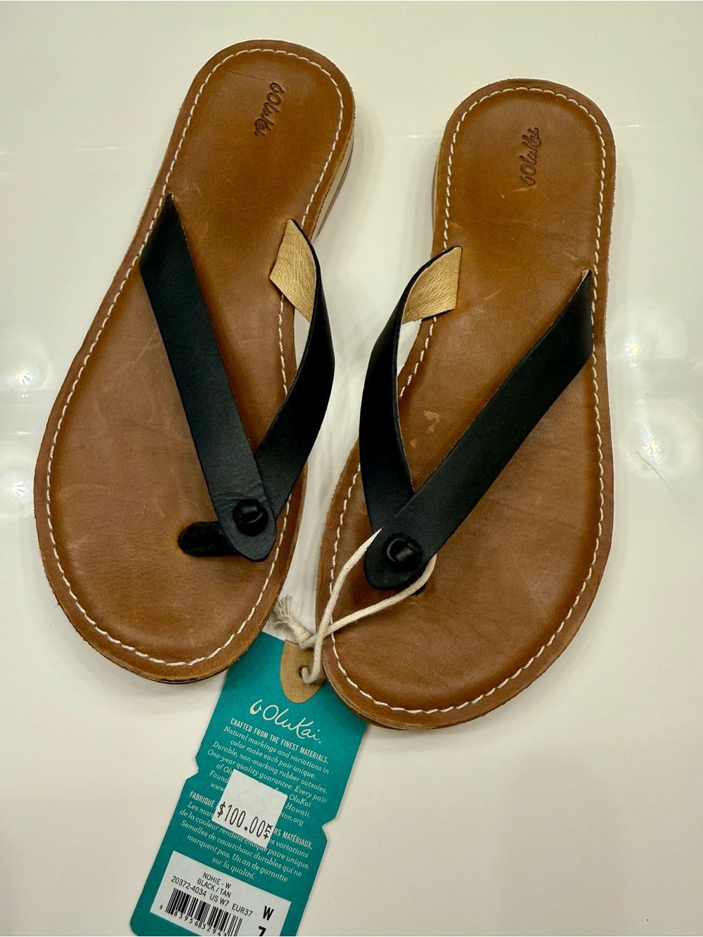 OluKai Women's Tan Leather Flip Flops with Black Straps